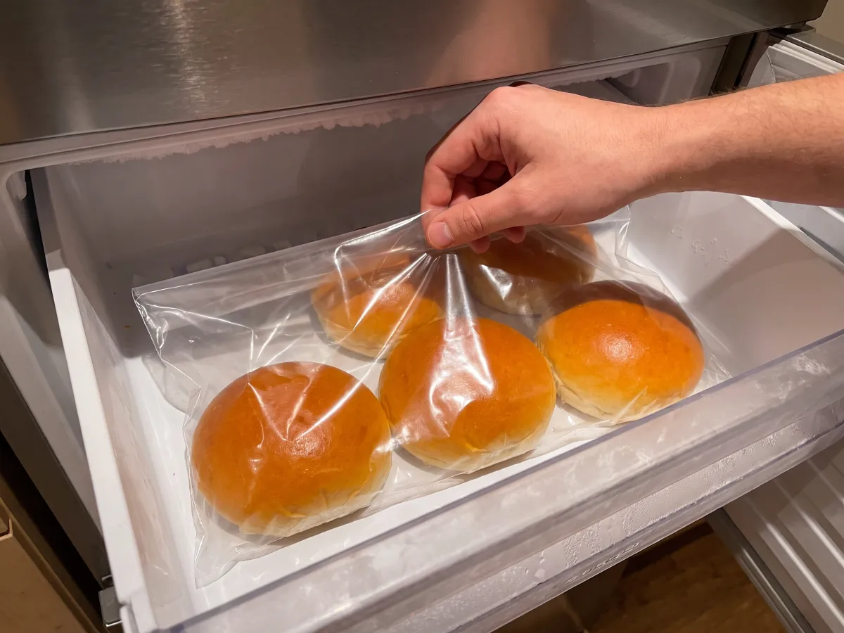 Bag of brioche buns going into the freezer drawer